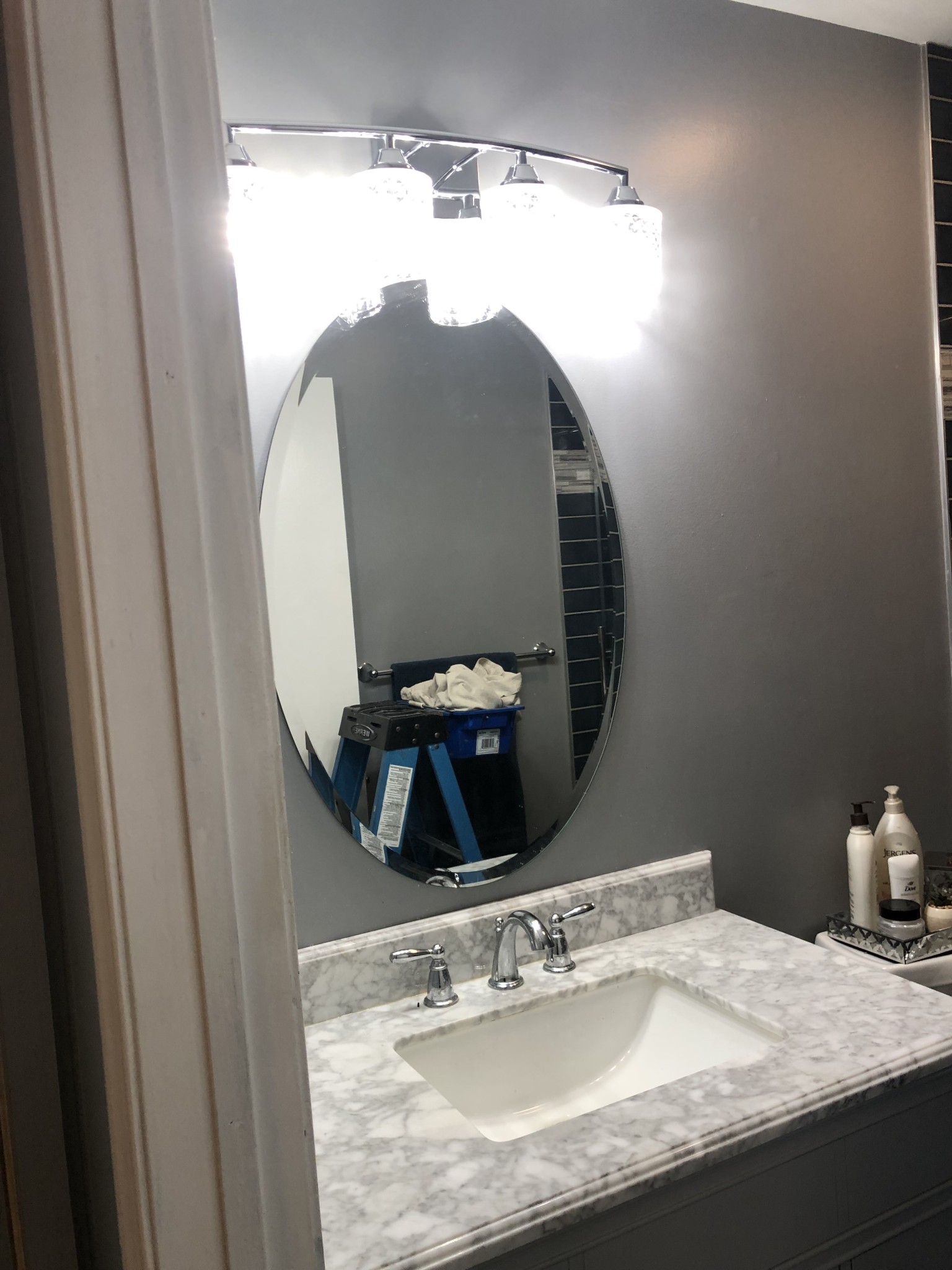 Installed a sharp bathroom vanity light. Plus, energy-efficient Feit Electric LED bulbs.