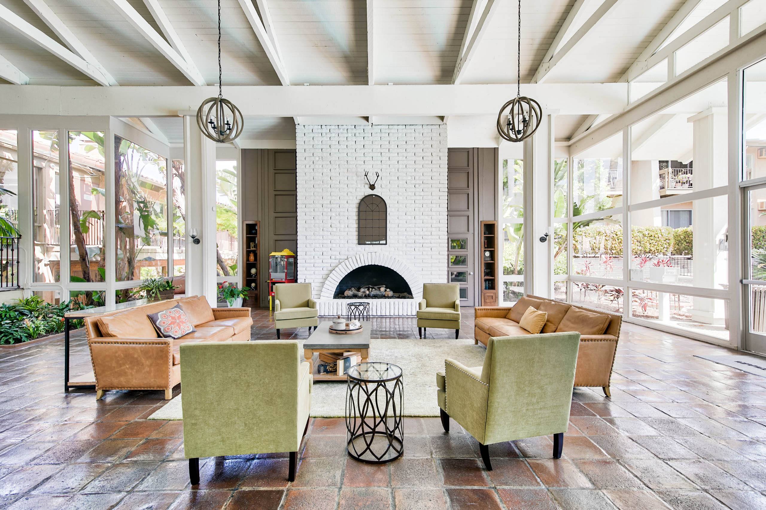 a living room with couches and chairs and a fireplace