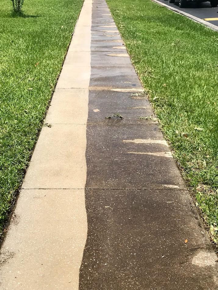 Professional sidewalk pressure washing in Davenport, FL, removing dirt, algae, mildew, and buildup from concrete.
