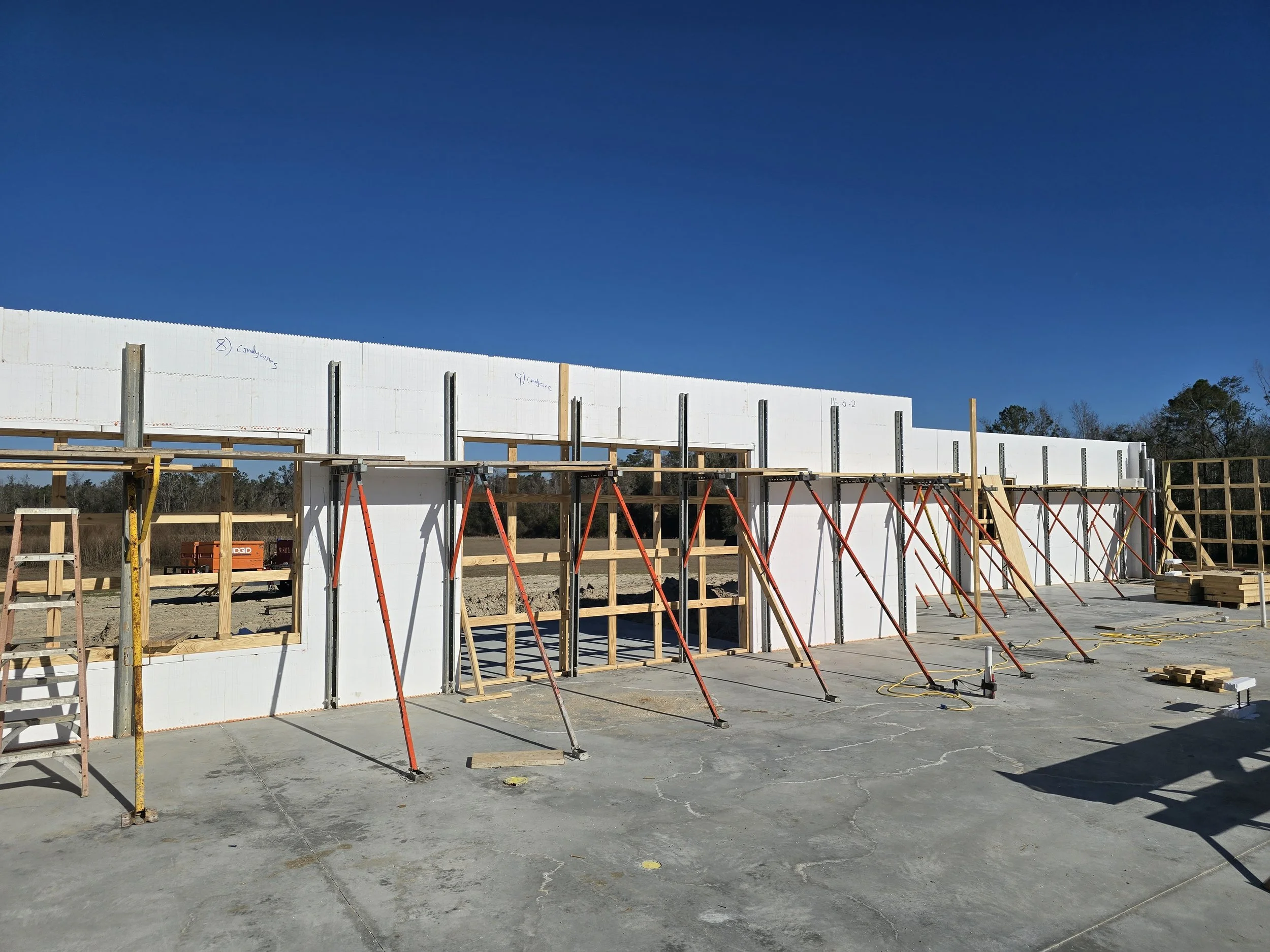 A construction site with a building under construction using Insulated Concrete Forms (ICFs). The IC 