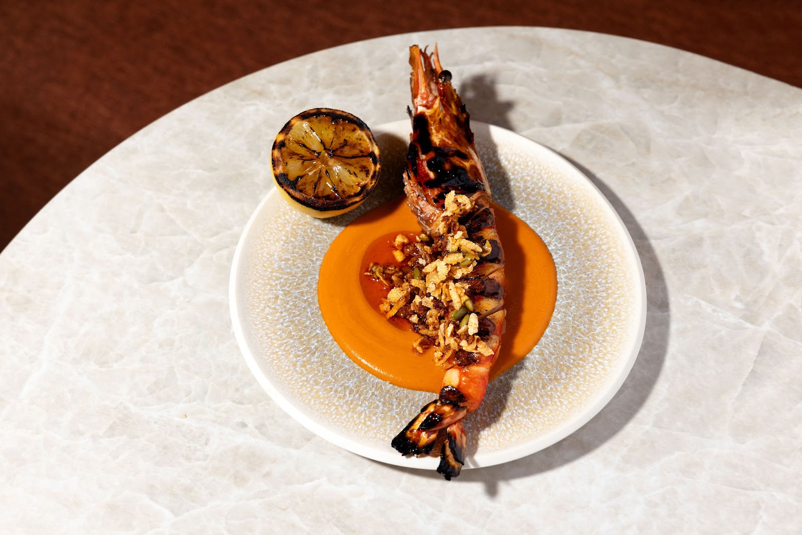 Grilled prawn from the Markette kitchen, part of the In Between section on the seasonal dinner menu. Served in the dining room in Chelsea, Manhattan.