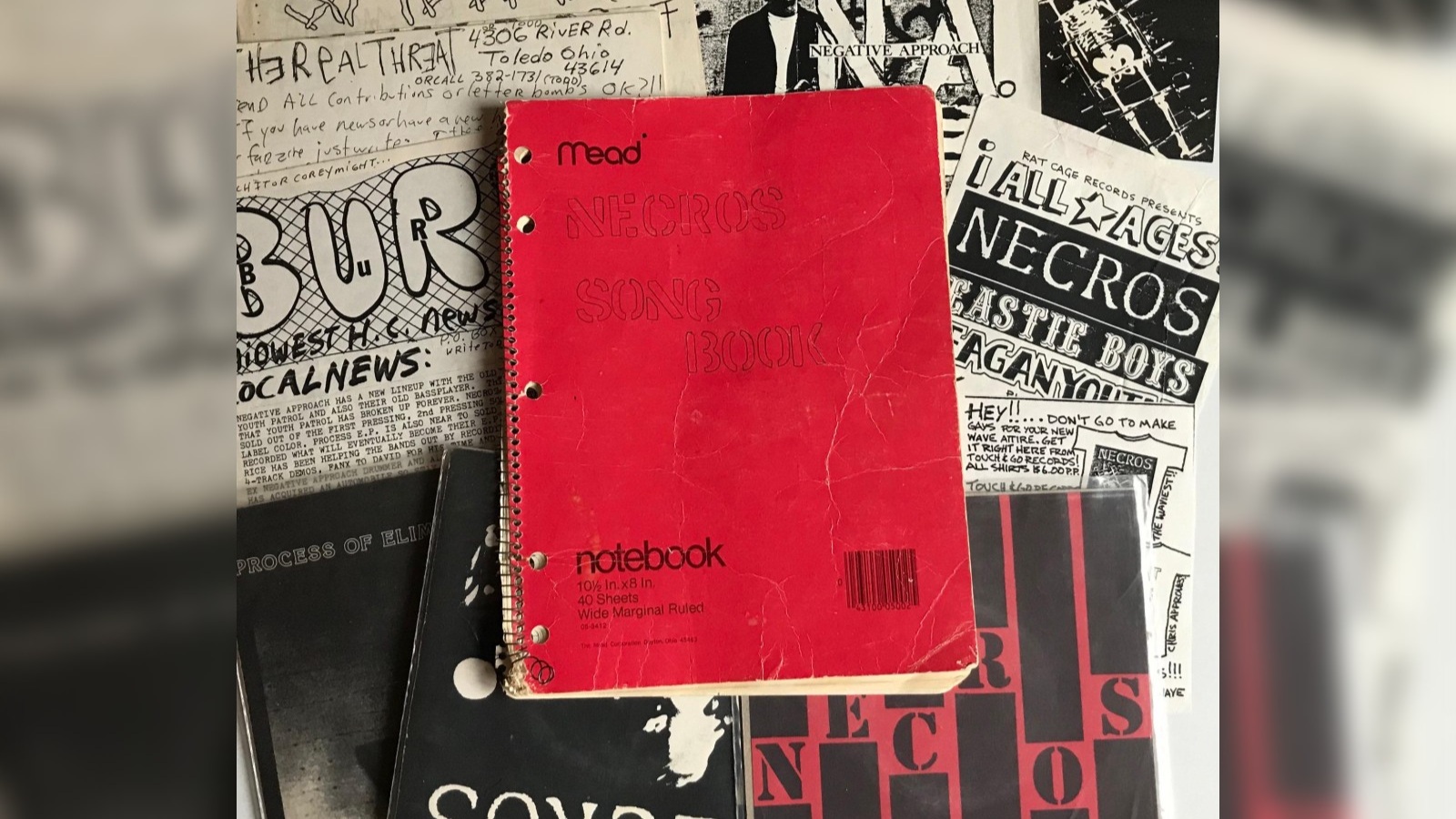 Necros song book exhibit featuring underground lyric collections, Midwest punk influence, and archival music documents.
