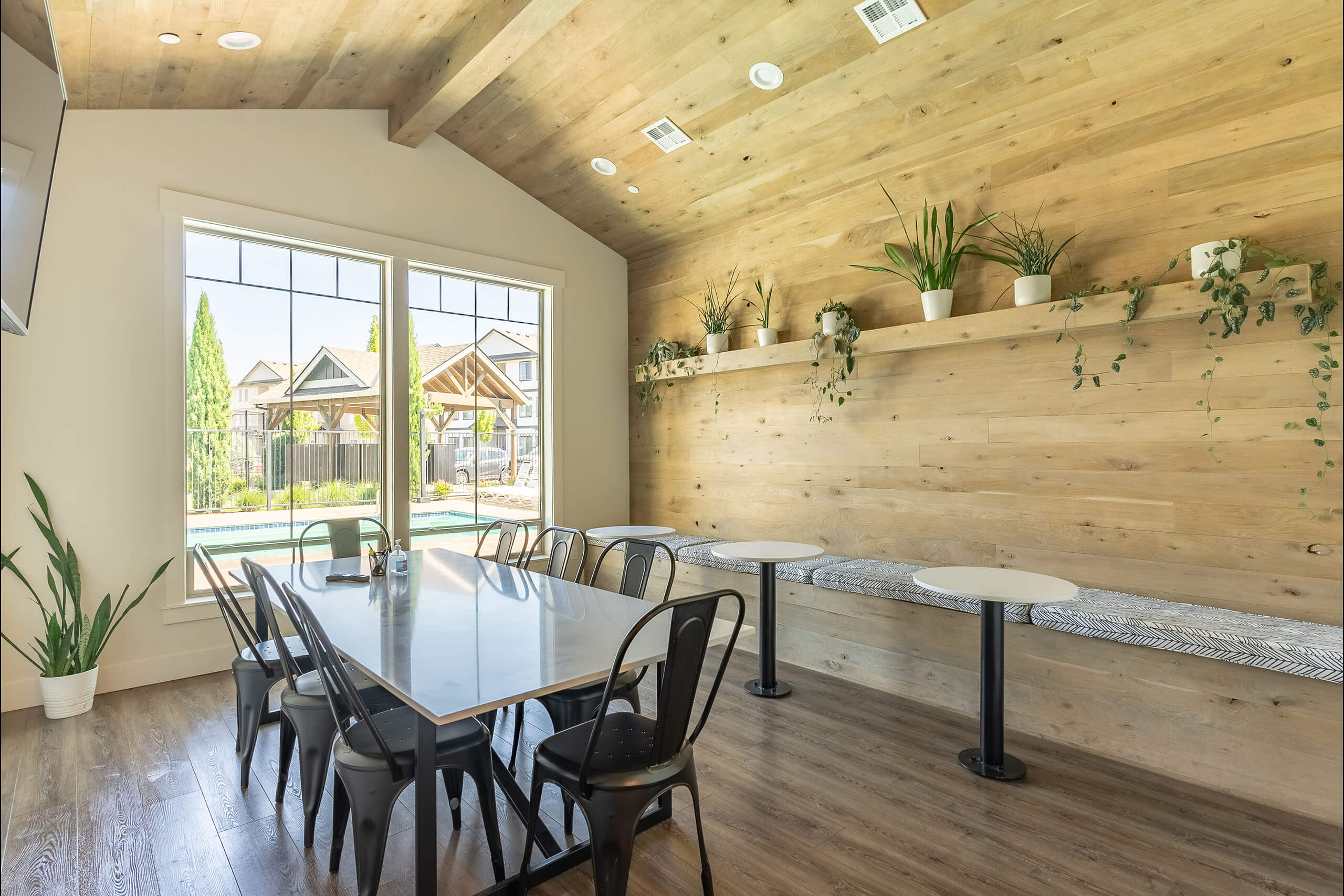 A dining room with a table and chairs.