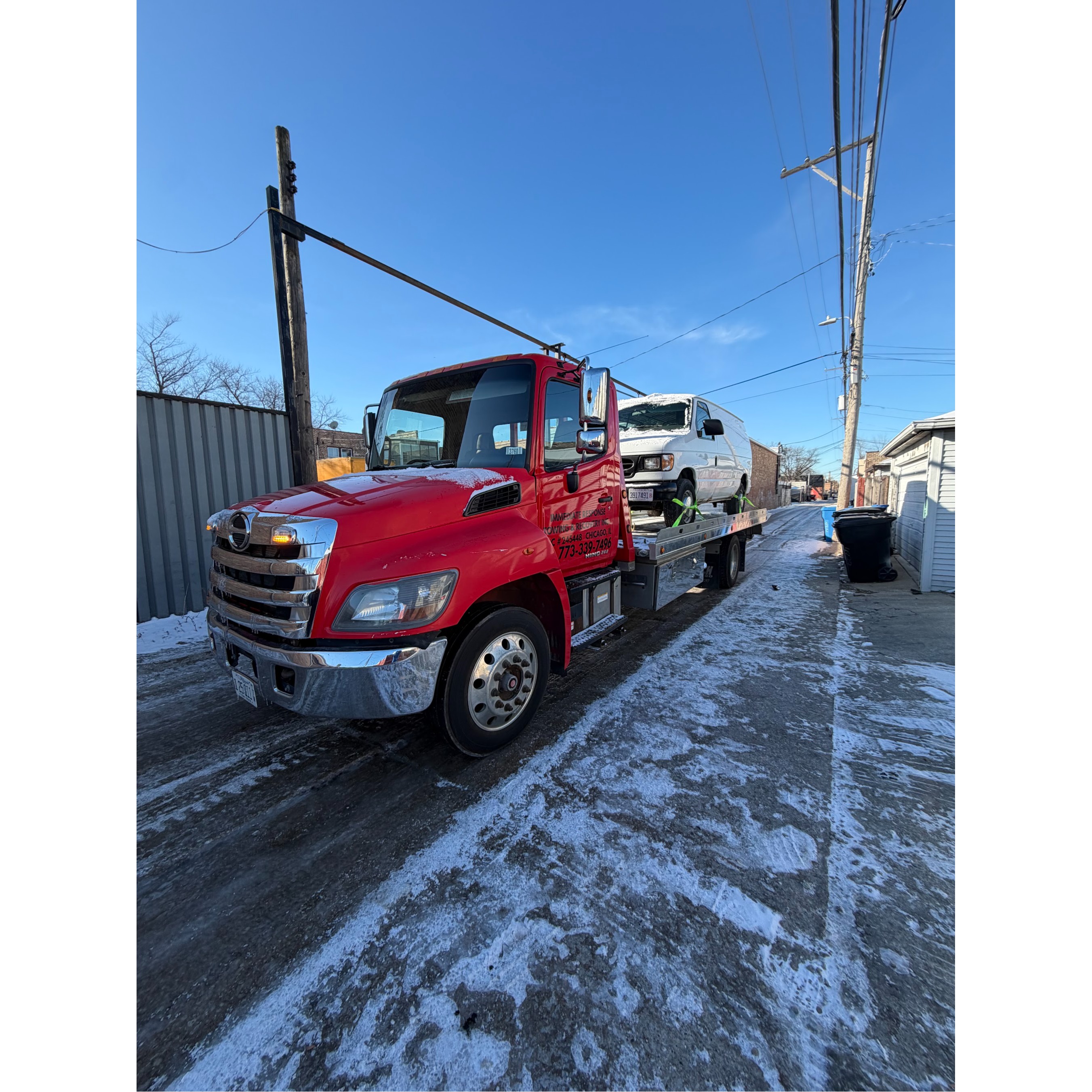 Immediate Response Towing & Recovery Chicago flatbed tow truck transporting a white commercial van t 