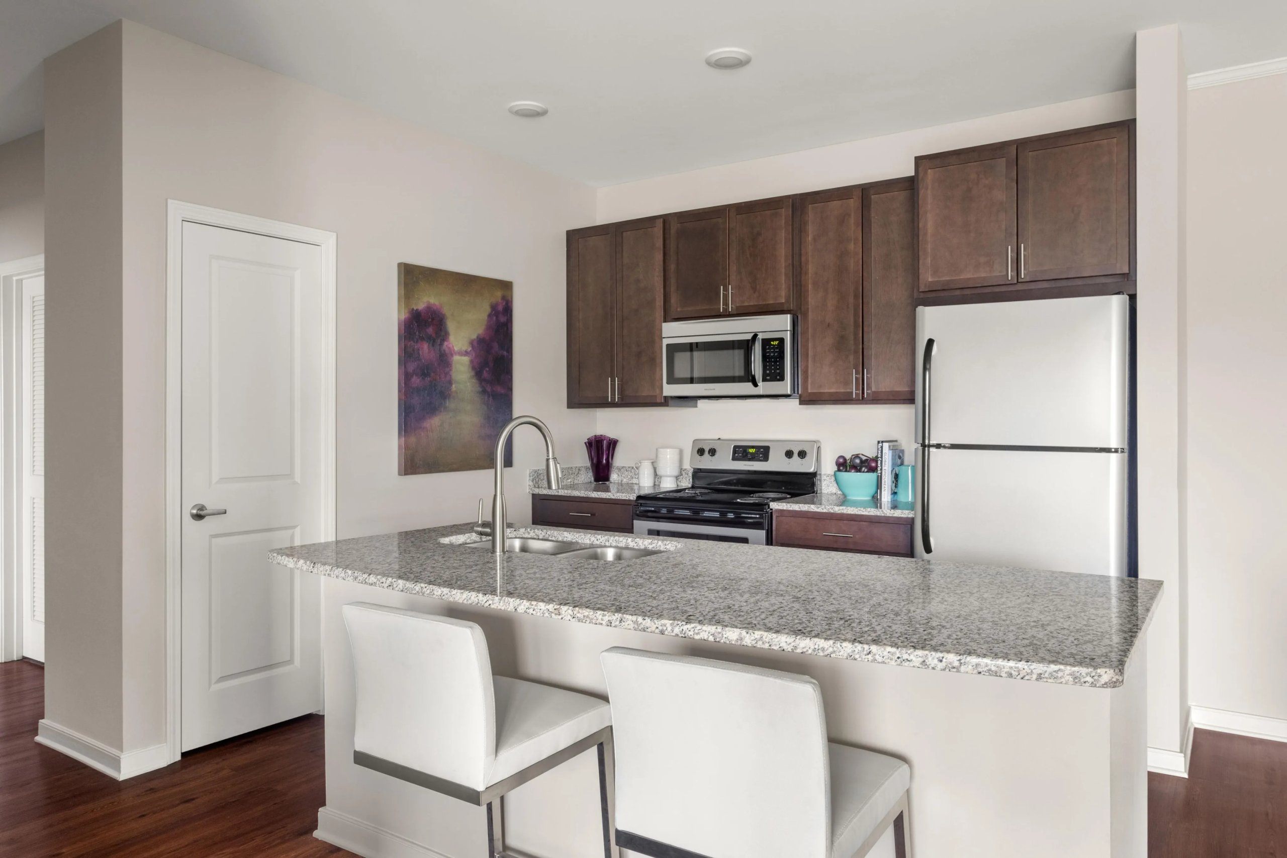 Modern kitchen with island seating and granite countertops