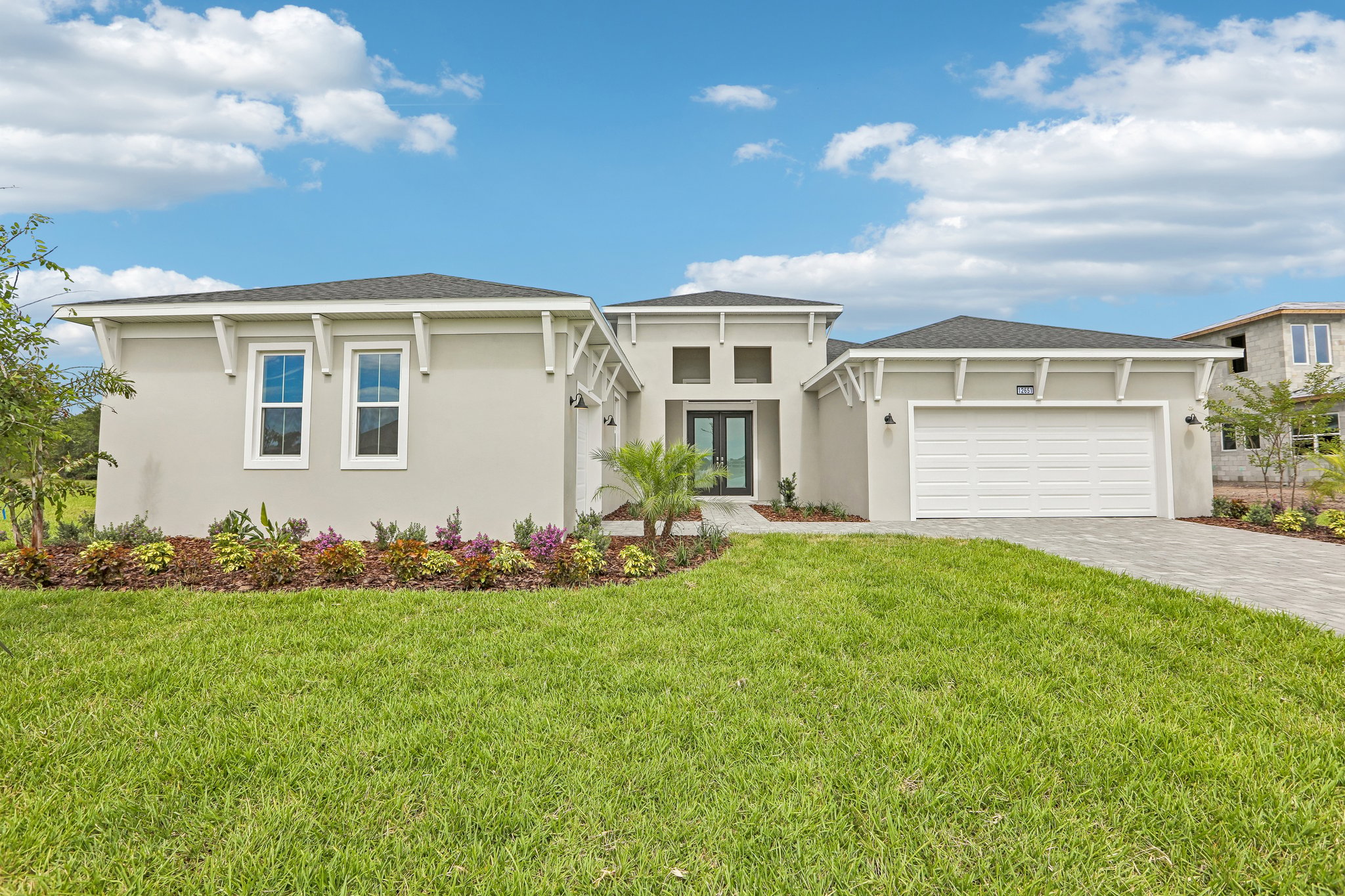 The Front Elevation of a DRB Homes Sabal Home Plan at Serengeti in Spring Hill, FL. 