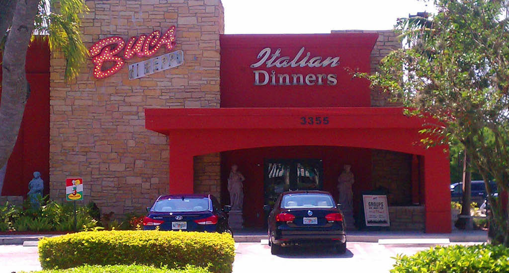 Buca sign on brick and Italian Dinners sign on red at the Buca di Beppo in Davie.