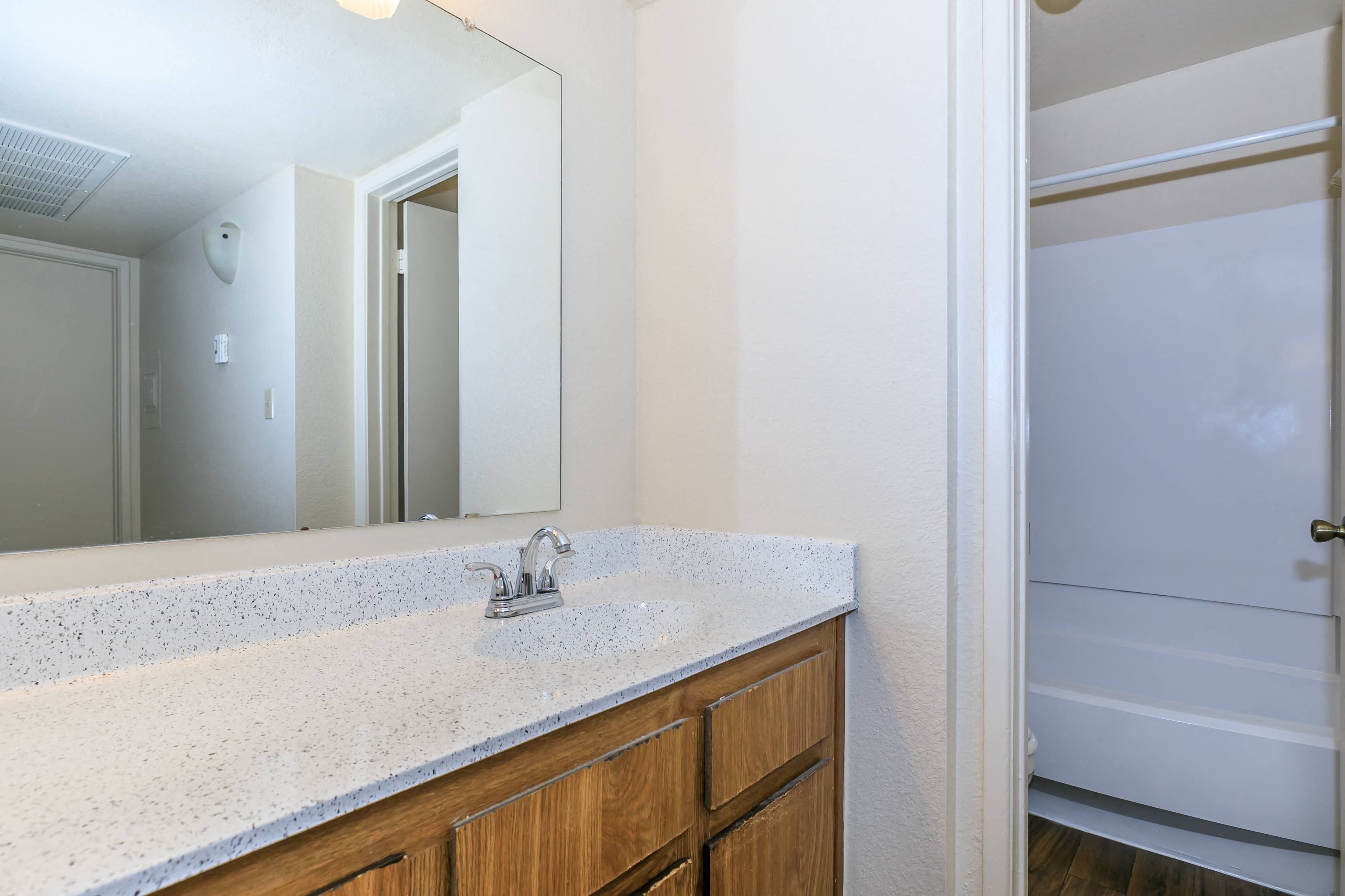 apartment bathroom with sink and mirror