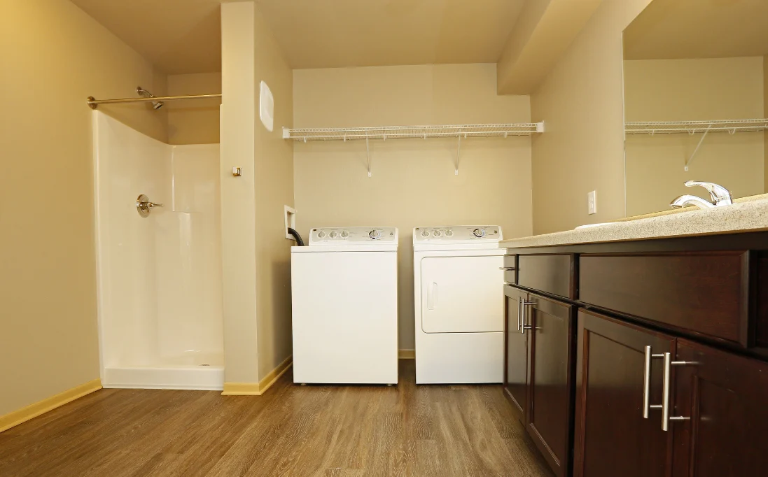 Room with kitchen island and in-unit washer & dryer