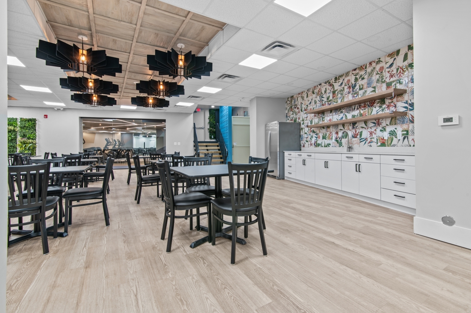 This image features a beautifully designed community dining and gathering area at Solaire Senior Living in Southfield, MI, created to encourage social connection and comfortable everyday living for residents 62 years of age and better. The modern space includes stylish lighting, spacious seating, and contemporary finishes that provide a welcoming environment for community events, weekly activities, and casual gatherings. As part of this luxury senior apartment community, residents enjoy thoughtfully designed shared spaces that support an active and engaging senior lifestyle.