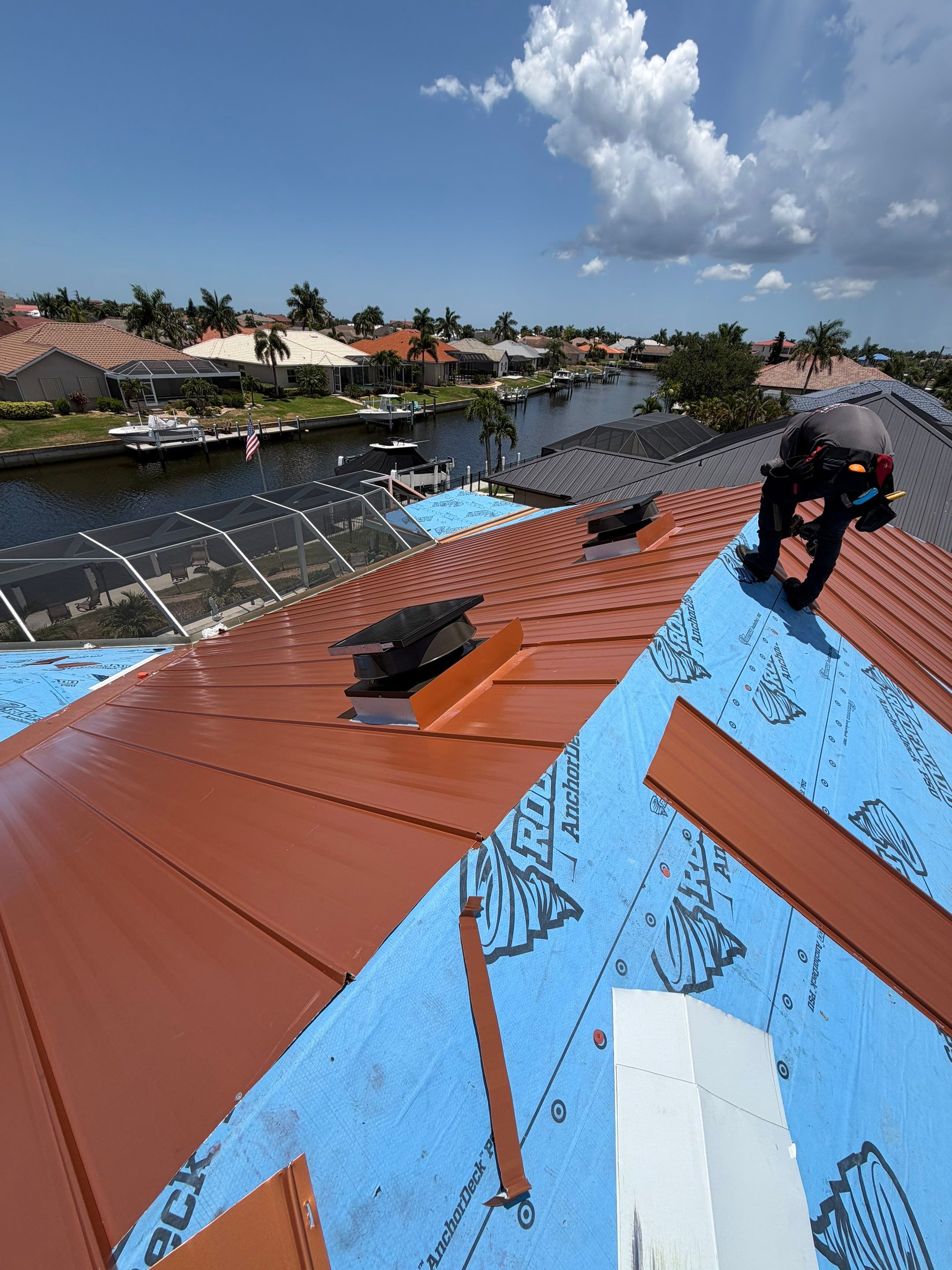 Tile roof repair in progress, with damaged or removed roof tiles exposing the underlayment beneath. 