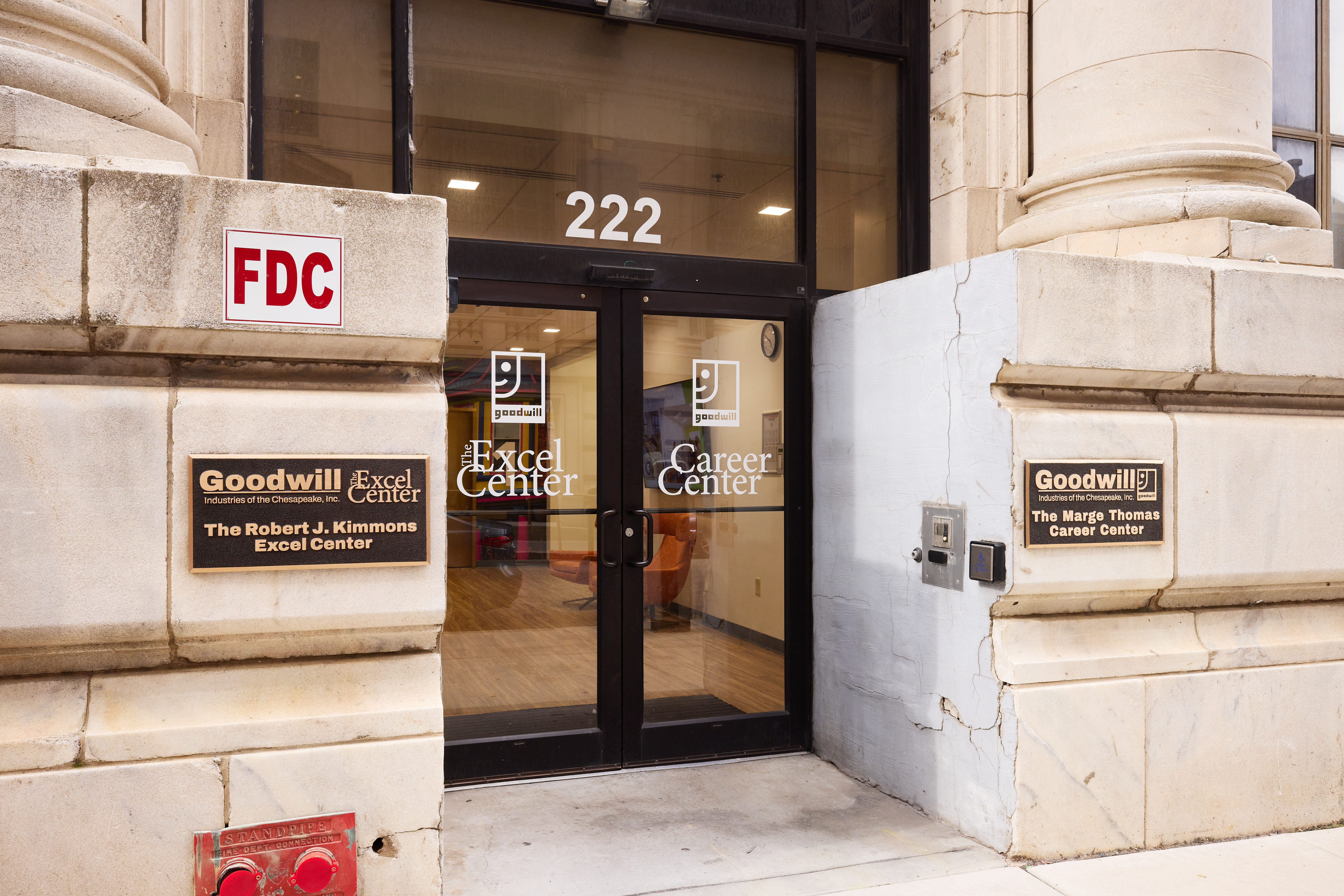 Exterior Image of Entryway, labeled doors and plaques are shown for the Career Center and Excel Center
