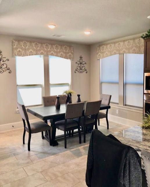 Bring continuity to your home's open floor plan with the right window treatments. Roller Shades and Custom Cornices by Budget Blinds of Katy & Sugar Land bring harmony to this dine-in kitchen. #BudgetBlindsKatySugarLand #RollerShades #ShadesOfBeauty #CustomCornices #FreeConsultation