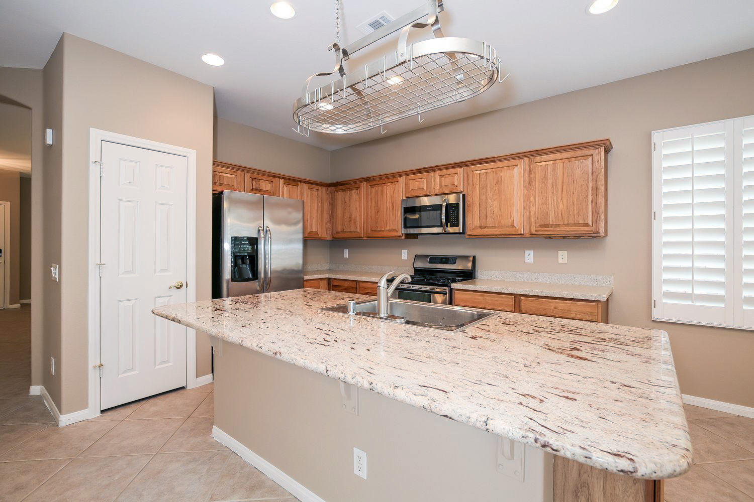 gorgeous kitchen in Las Vegas equipped with stainless steel appliances and granite countertops by Invitation Homes