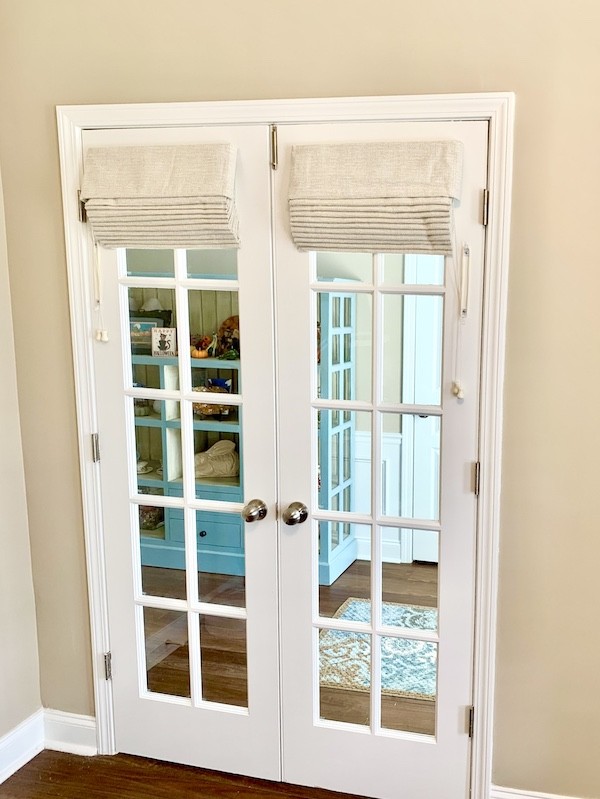 Enhance your living space with our decorative roman shades!  With their elegant folds and chic fabric, our gorgeous roman shades add a stylish twist to these french doors in a local Hilton Head Island home. Let’s get started on your next home project- schedule your free in-home design consultation w