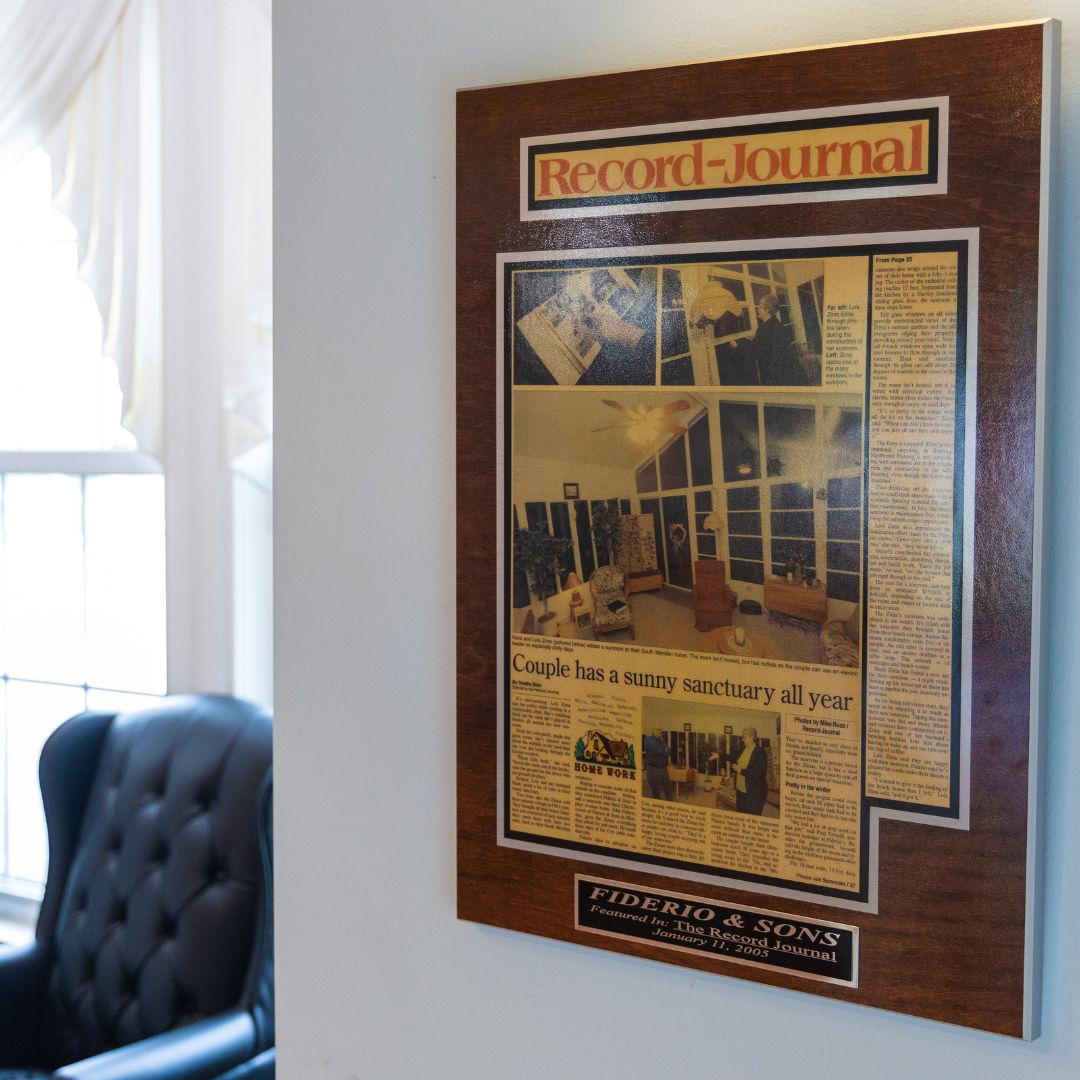Framed article from the Record-Journal featuring Fiderio & Sons' sunroom work in a local home.