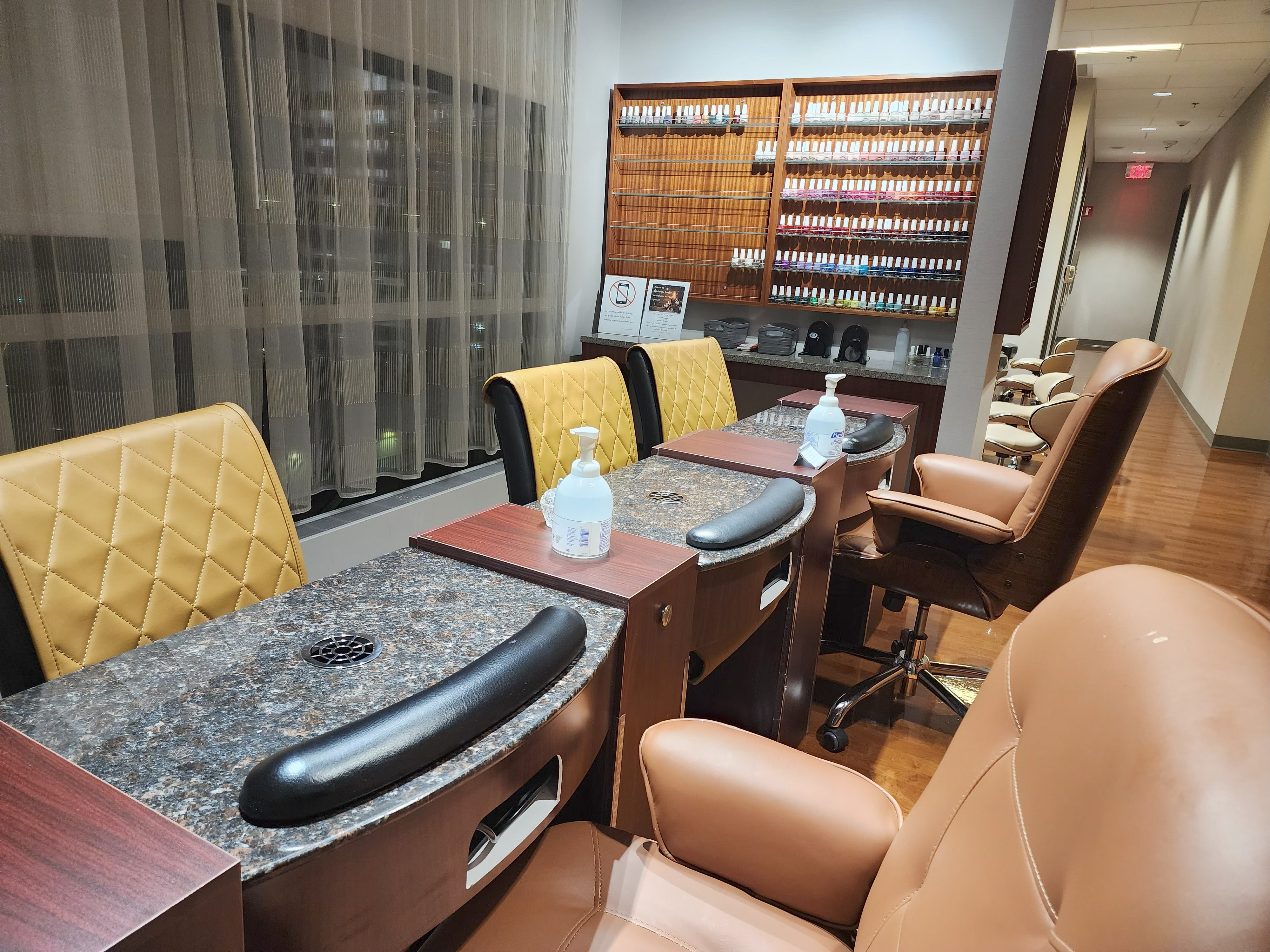 Manicure area with seated nail stations and modern finishes