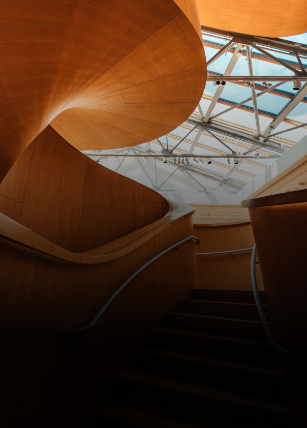 Upward view of the Frank Gehry spiral wooden staircase within the Art Gallery of Ontario.