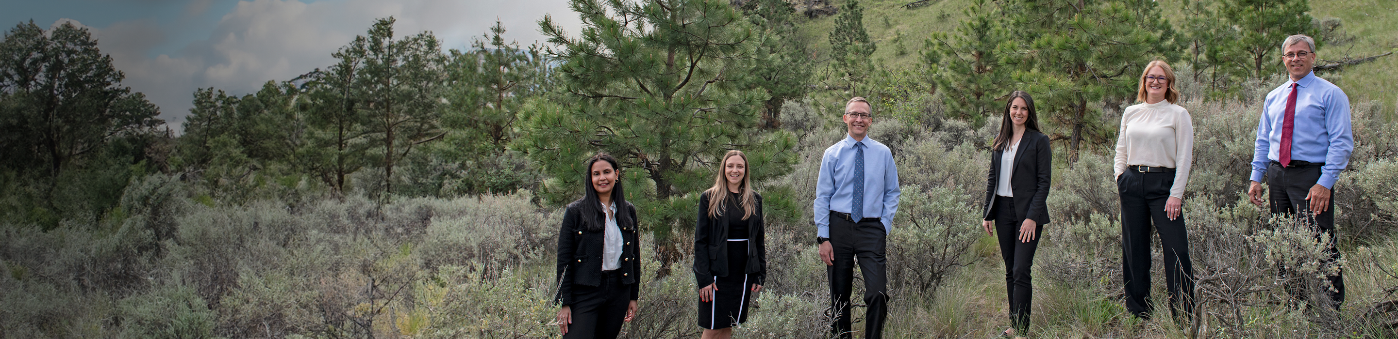The Feistmann Wealth Management team, standing together on a hillside.