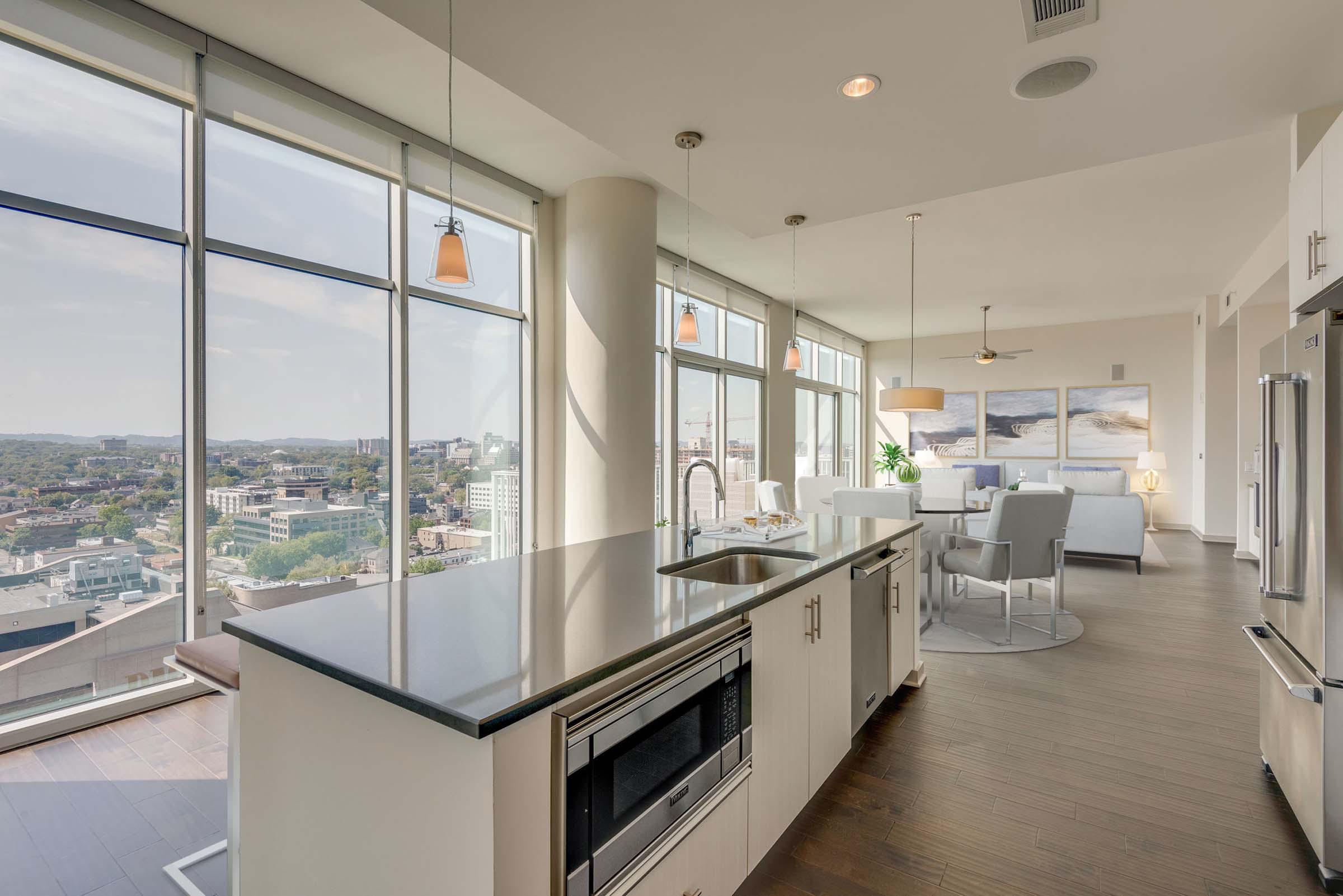 Camden Music Row Apartments Penthouse kitchen with island, floor to ceiling windows, room for dining, built-in appliances