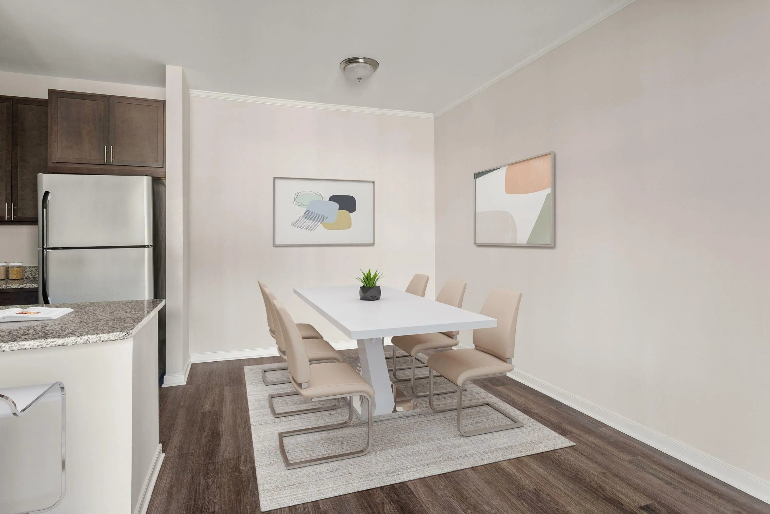 Dining area with modern white table and upholstered chairs