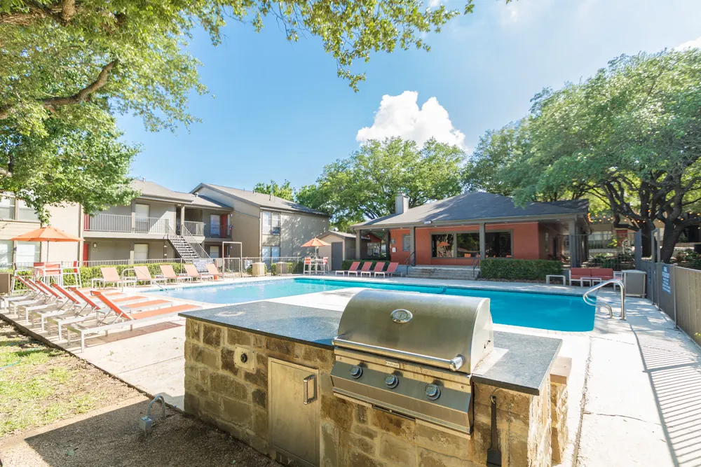 Pool area with outdoor grill and lounge seating