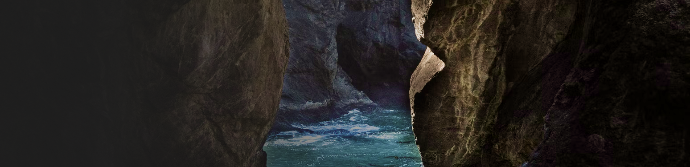 View of rushing water as seen through rockfaces.