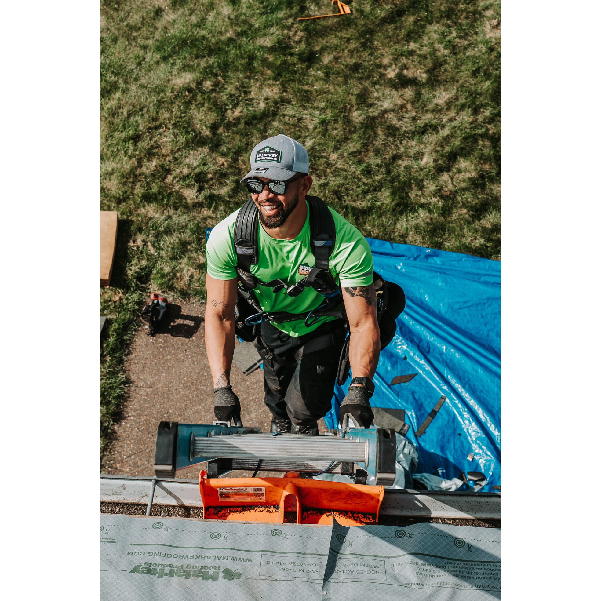 Roofing professional using specialized tools while completing residential roof work. 