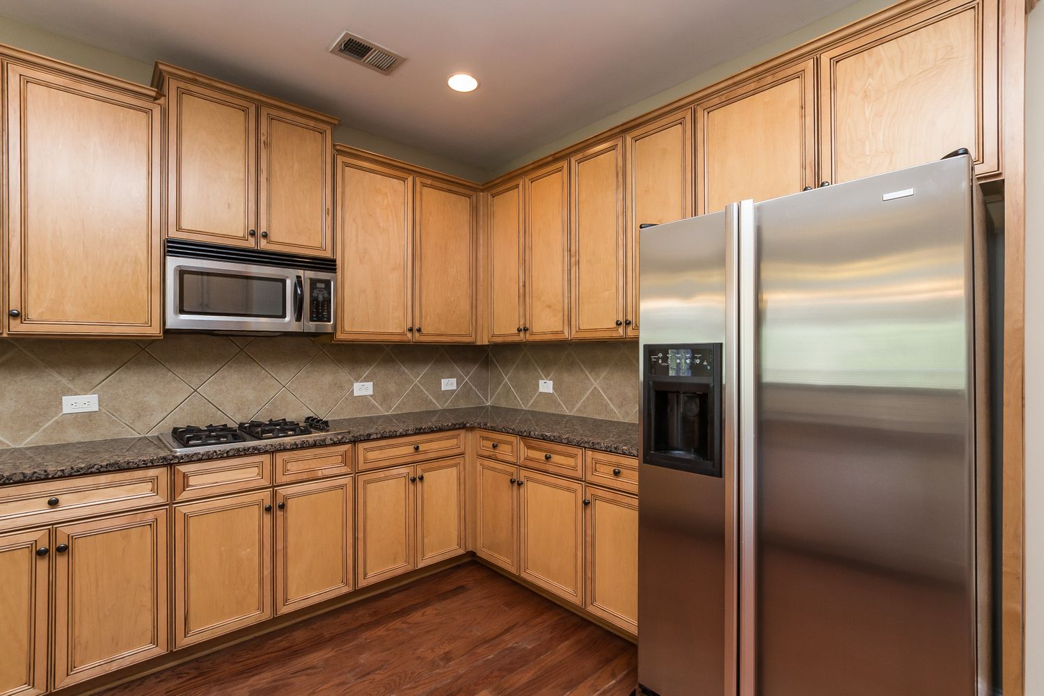 Kitchen with stainless steel appliances at Invitation Homes Atlanta.