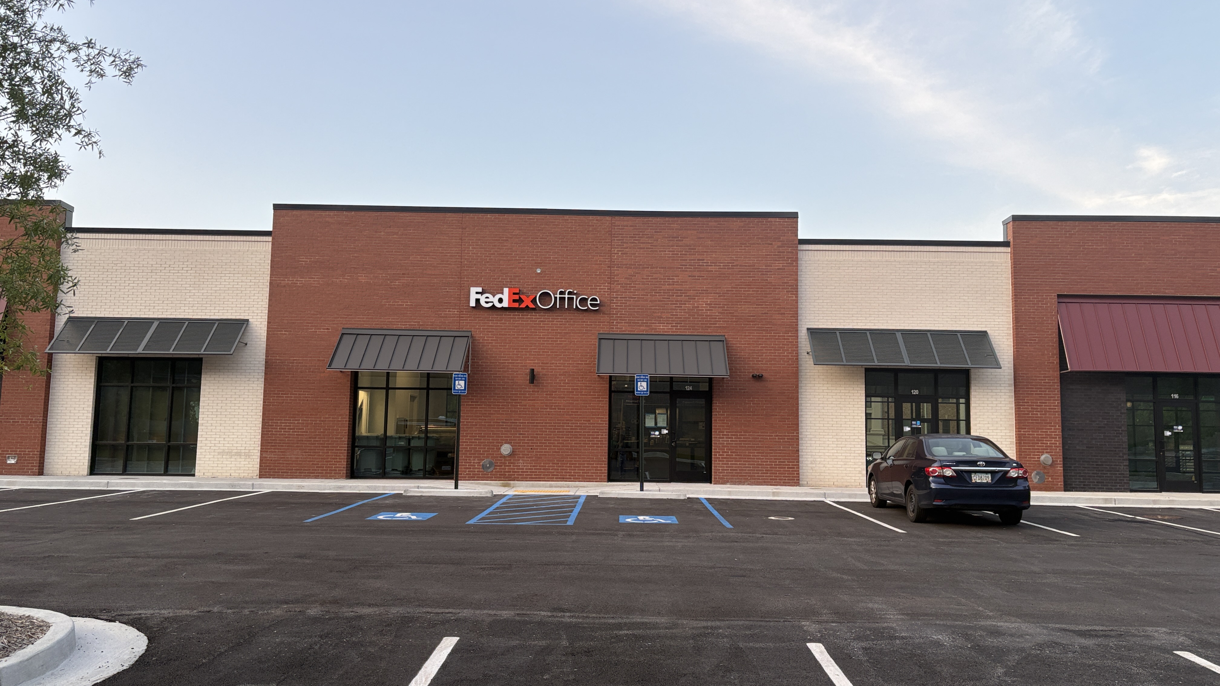 The main storefront of the FedEx Office in Atlanta, GA, located at Vinings Slope SE, with designated accessible parking spaces directly in front.