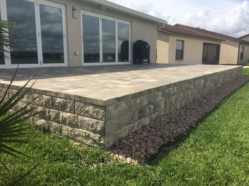 Constructed raised porch landing space was created for easy access in and out of the home with beautifully laid pavers that accent the home's exterior