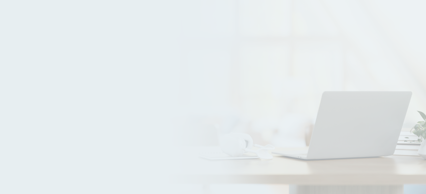 Desk with notebooks, a laptop, headphones, and a potted plant.