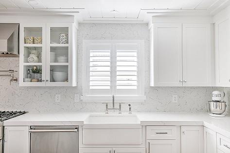 This kitchen is so bright and fresh! We wanted to add another wood element to match the ceiling and cabinetry—and our Plantation Shutters work perfectly!