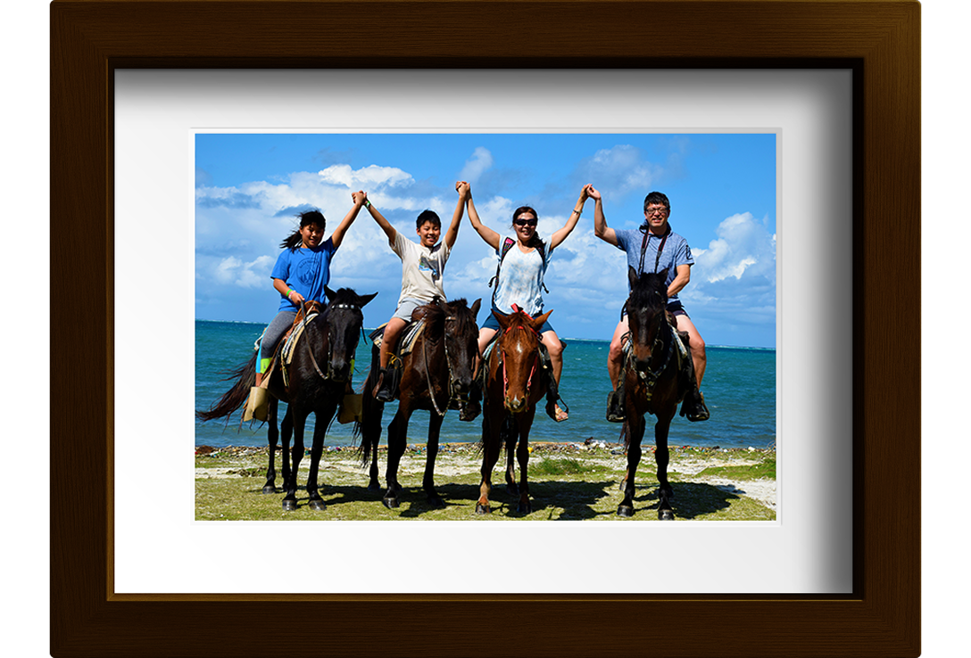 A picture of Johnny, Yolanda, and family on horseback.