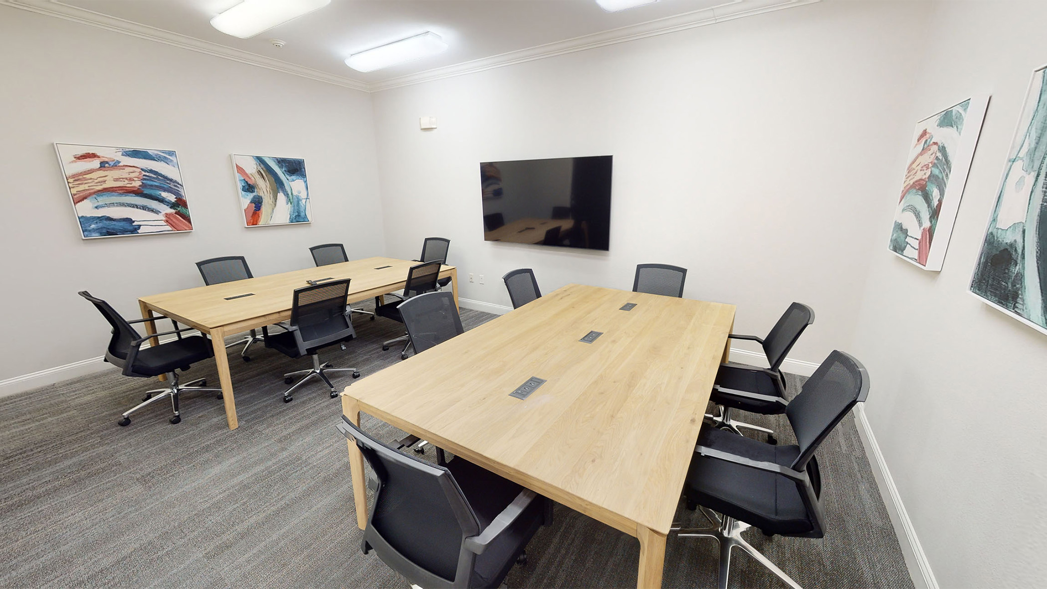 Twelve person conference room with two tables and a TV with HDMI hookup