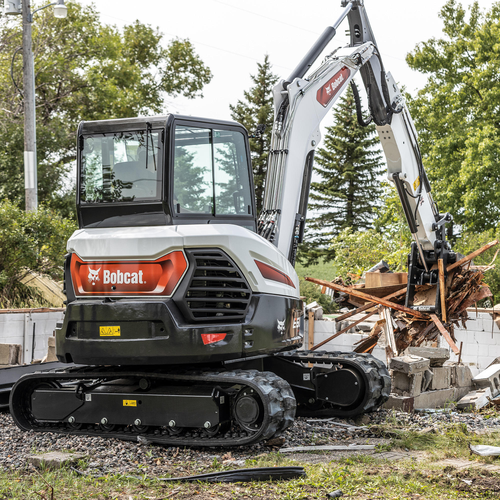 Bobcat E60 compact excavator performing demolition