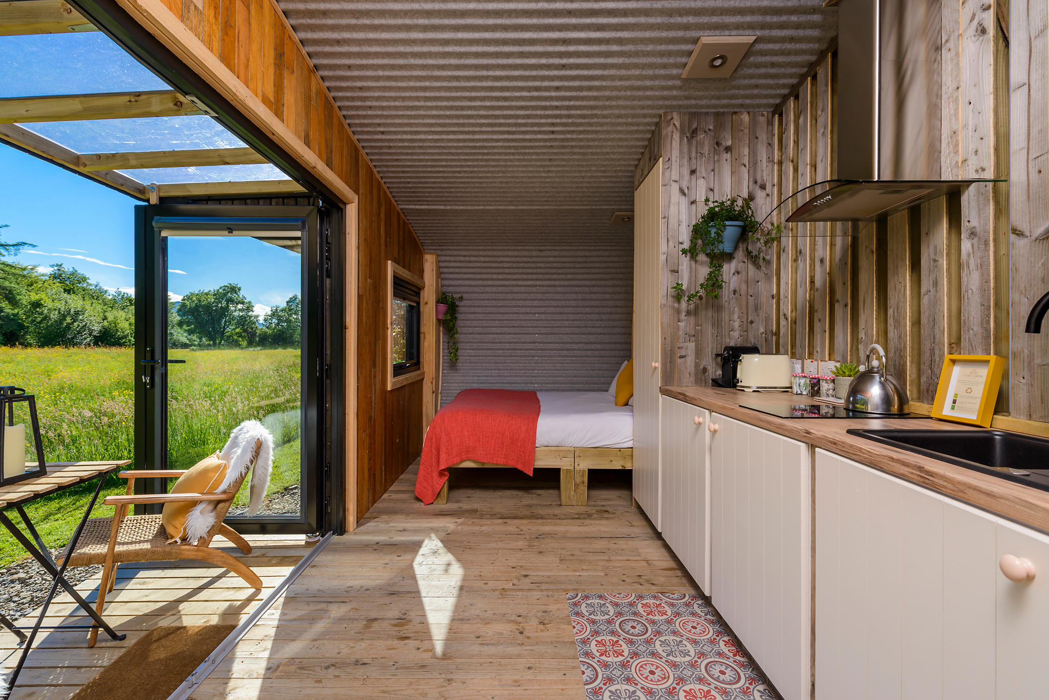 The Cabin interior boasts a King Size Bed, central heating, kitchenette with fridge to Nespresso mac Killarney Glamping At The Grove Kerry 087 975 0110