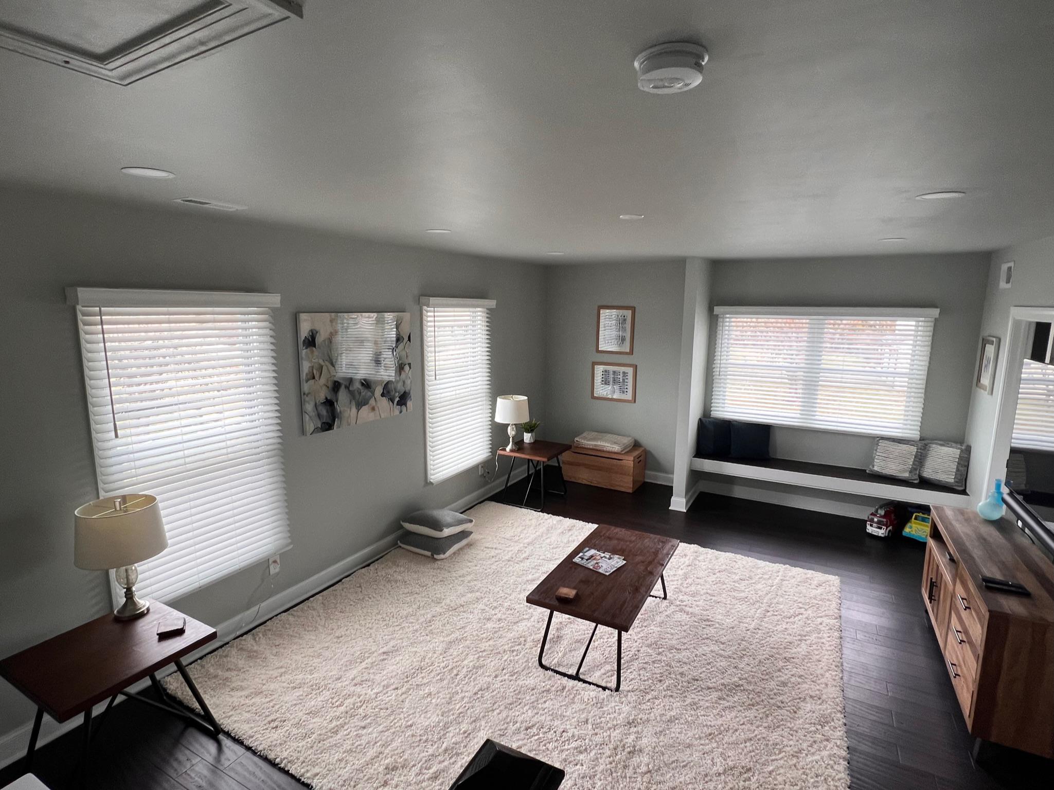 New bright white faux wood blinds will brighten up your King of Prussia living room.