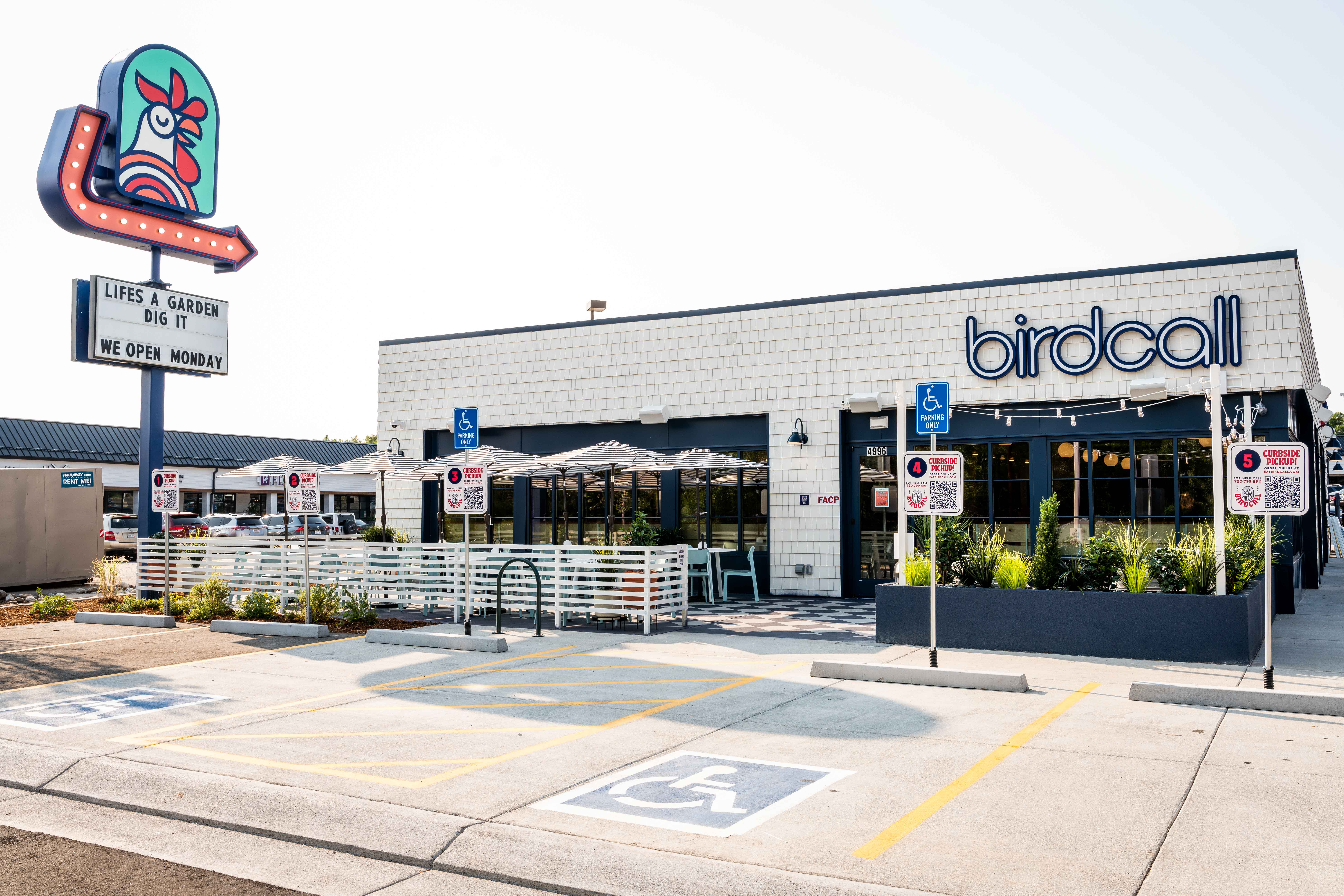 Birdcall Cherry Hills located on Hampden, features a large patio for dining and a fun marquee sign.