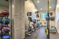 Fitness center with cardio equipment, TRX gear, and medicine balls.