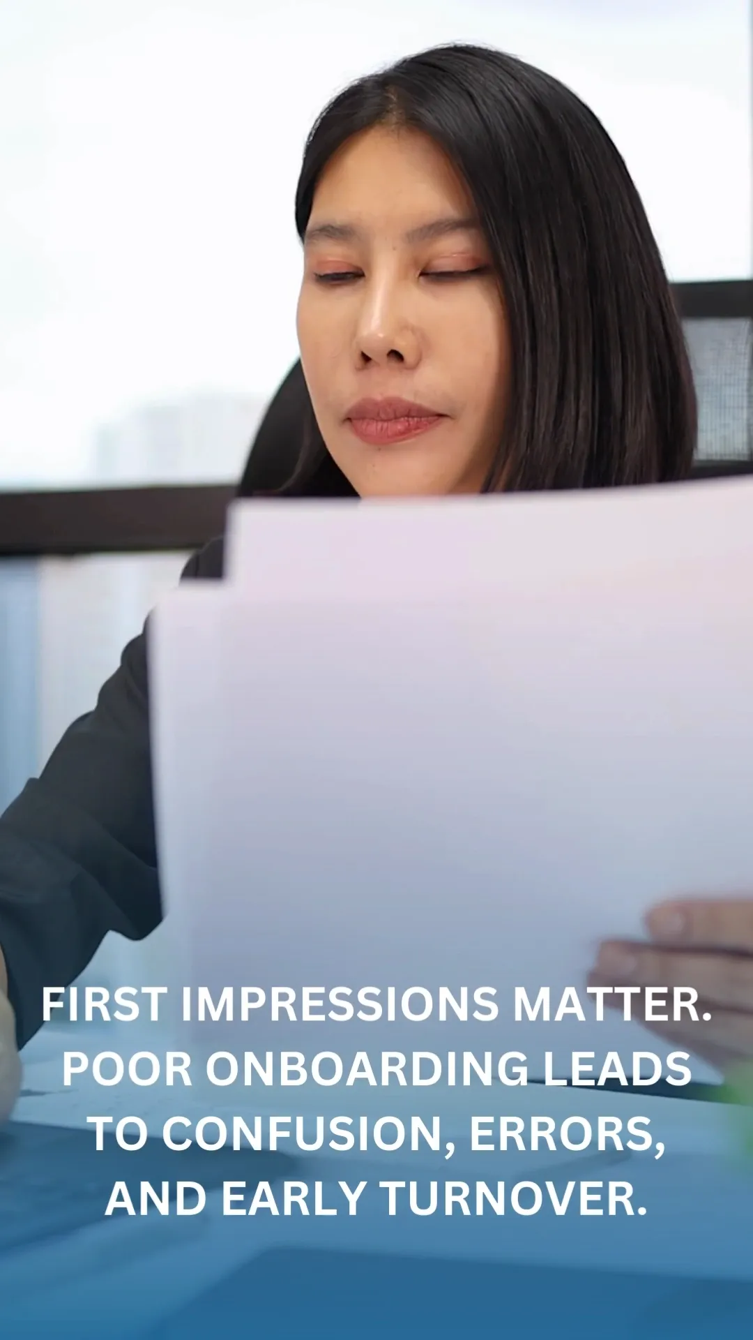 A woman with black hair and peach-colored eyeshadow is shown from the chest up, looking down at some papers she is holding. She is wearing a black blazer. The text "FIRST IMPRESSIONS MATTER. POOR ONBOARDING LEADS TO CONFUSION, ERRORS, AND EARLY TURNOVER." is superimposed on the lower portion of the image. The background is blurred, showing what appears to be an office setting with windows.