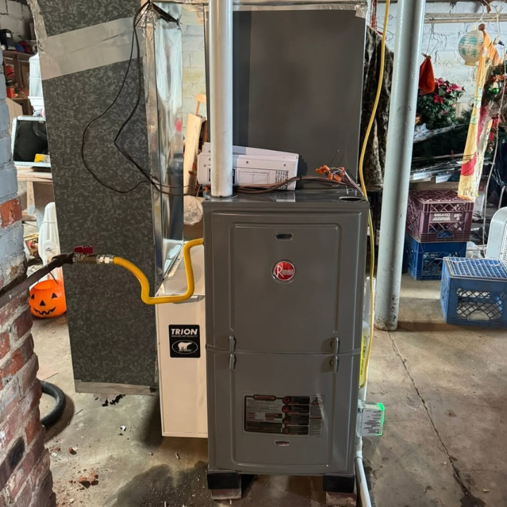 Horizontal Rheem air handler and new insulated ductwork in an attic installation.
