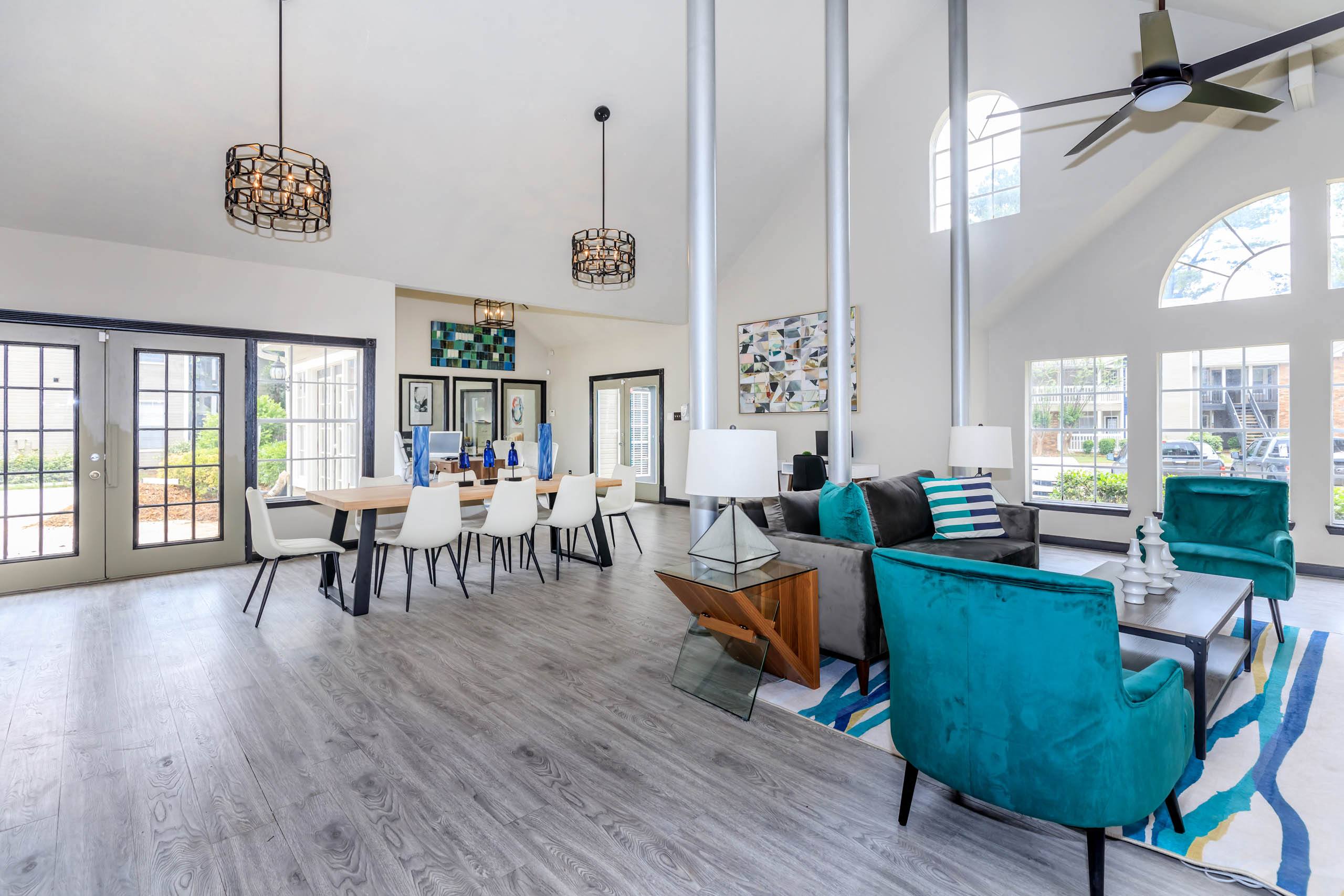 a living room and dining room with a table and chairs