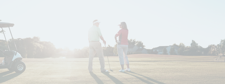Golf partners on the green at golden hour.