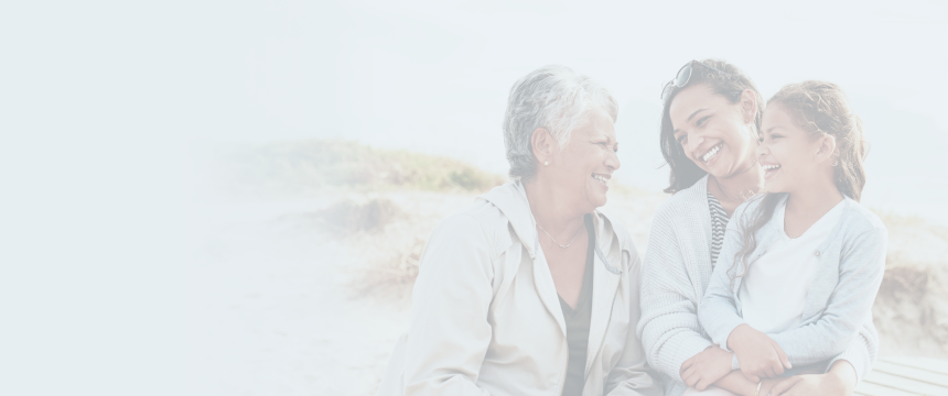 A grandmother with laughing with her daughter and granddaughter.