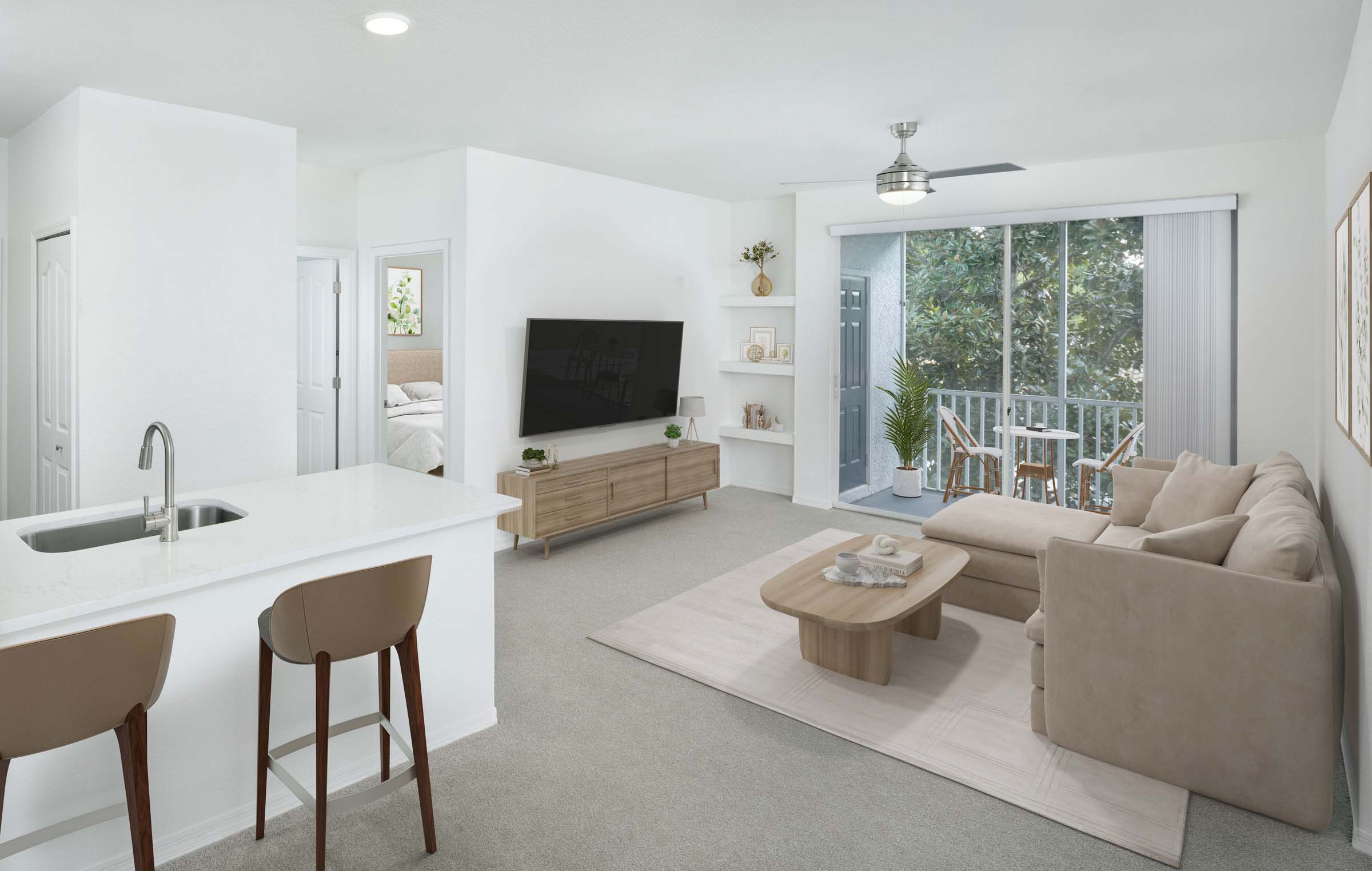 Living room with plush carpet, private balcony, and built-in shelves at Camden World Gateway apartments in Orlando, FL