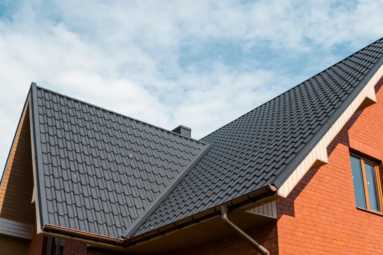 Durable tile roofing system installed on a brick home, offering excellent weather resistance and architectural beauty. Professional craftsmanship ensures reliable performance and long-term structural protection.