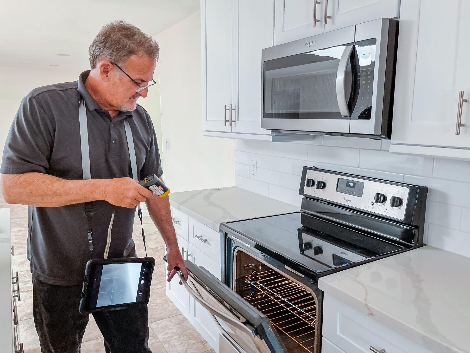 Jeff Hunter of Hunter Home Inspections inspects the oven temperature to ensure it's working correctly.