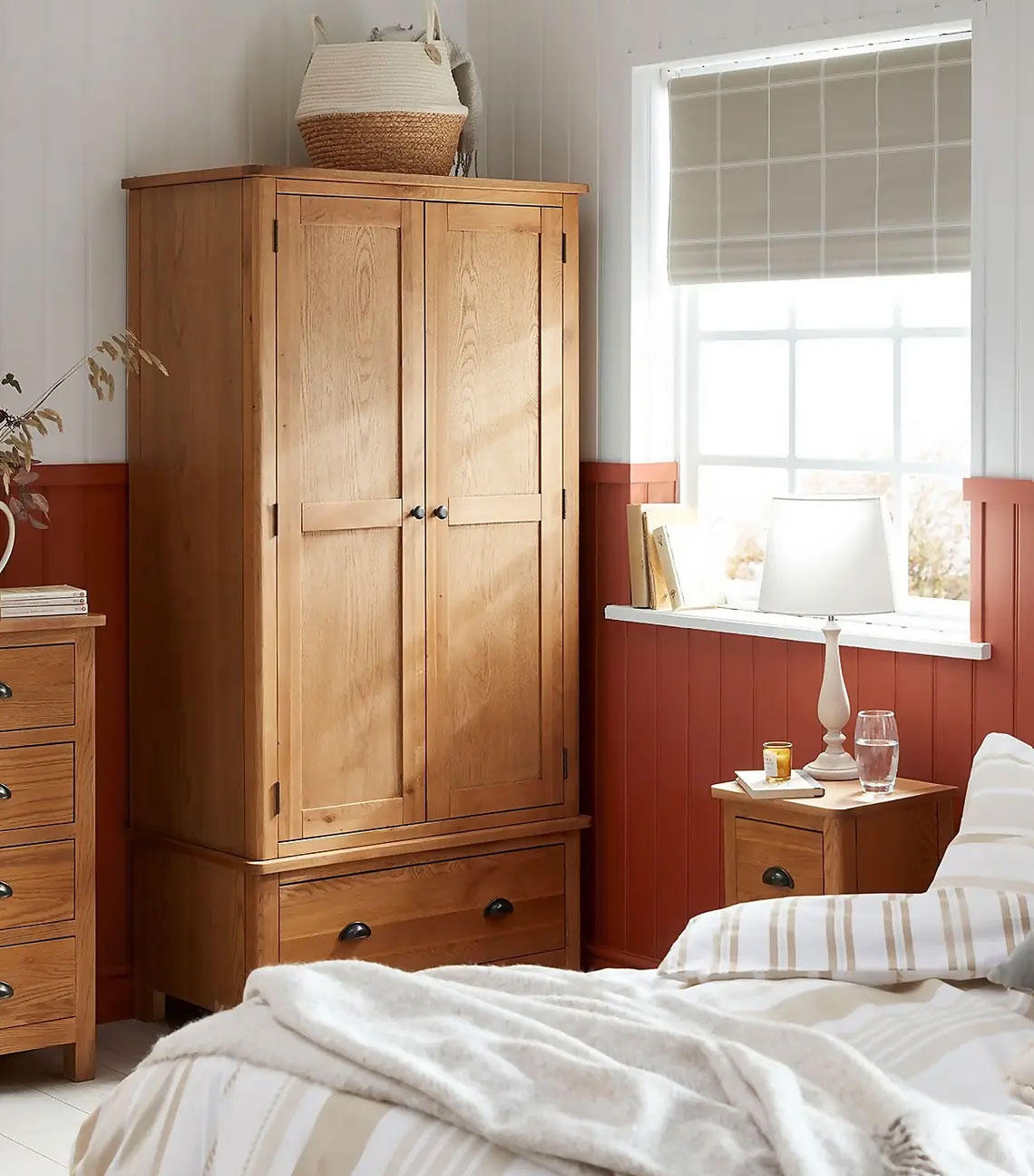 An oak freestanding hinged wardrobe with drawers