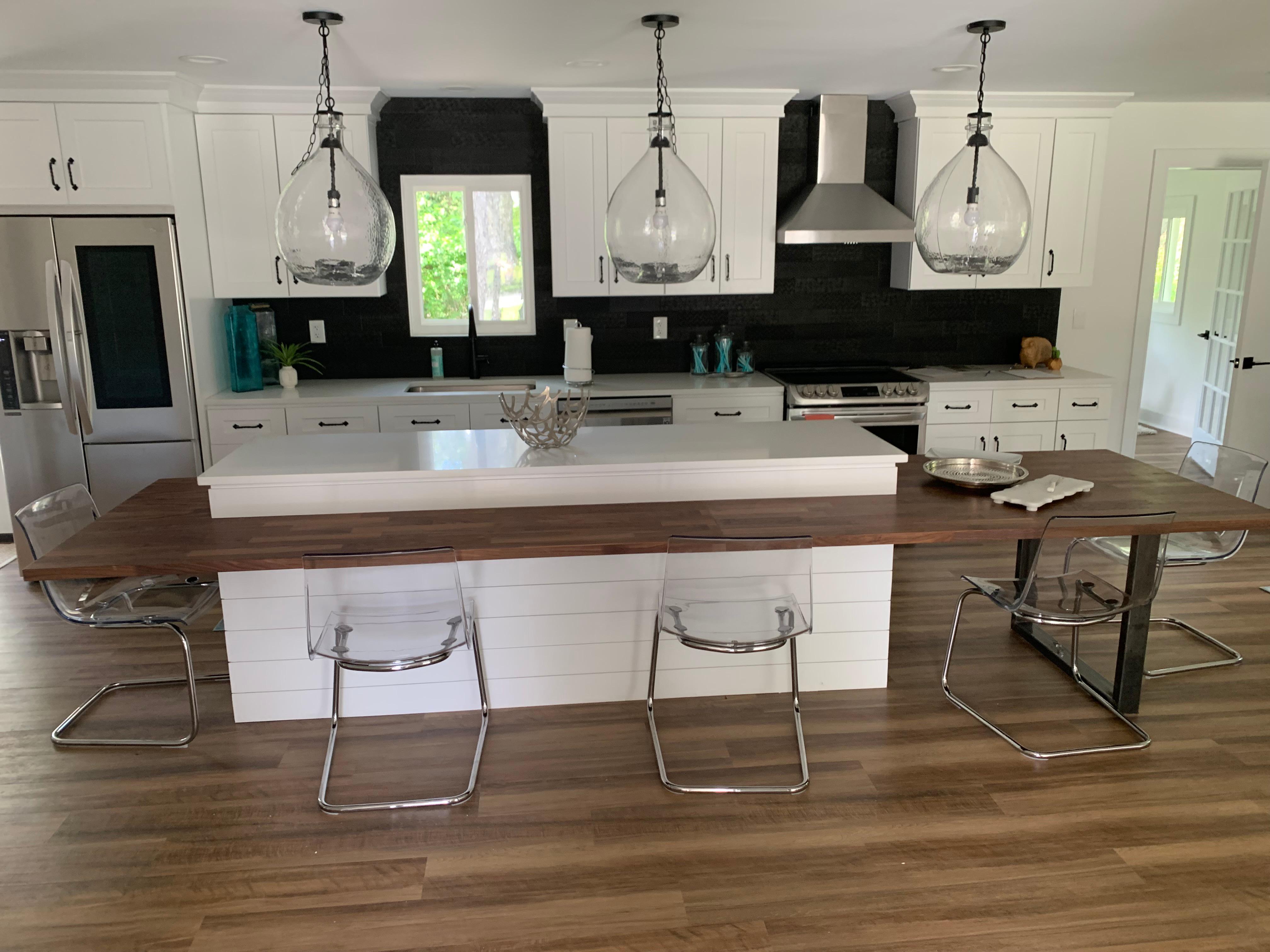 Fully updated kitchen with new white countertops and white cabinets.